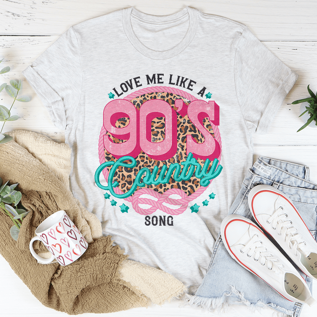 A stylish Love Me Like A 90's Country Song T-Shirt made of soft cotton, featuring a vibrant print that celebrates 90's country music.