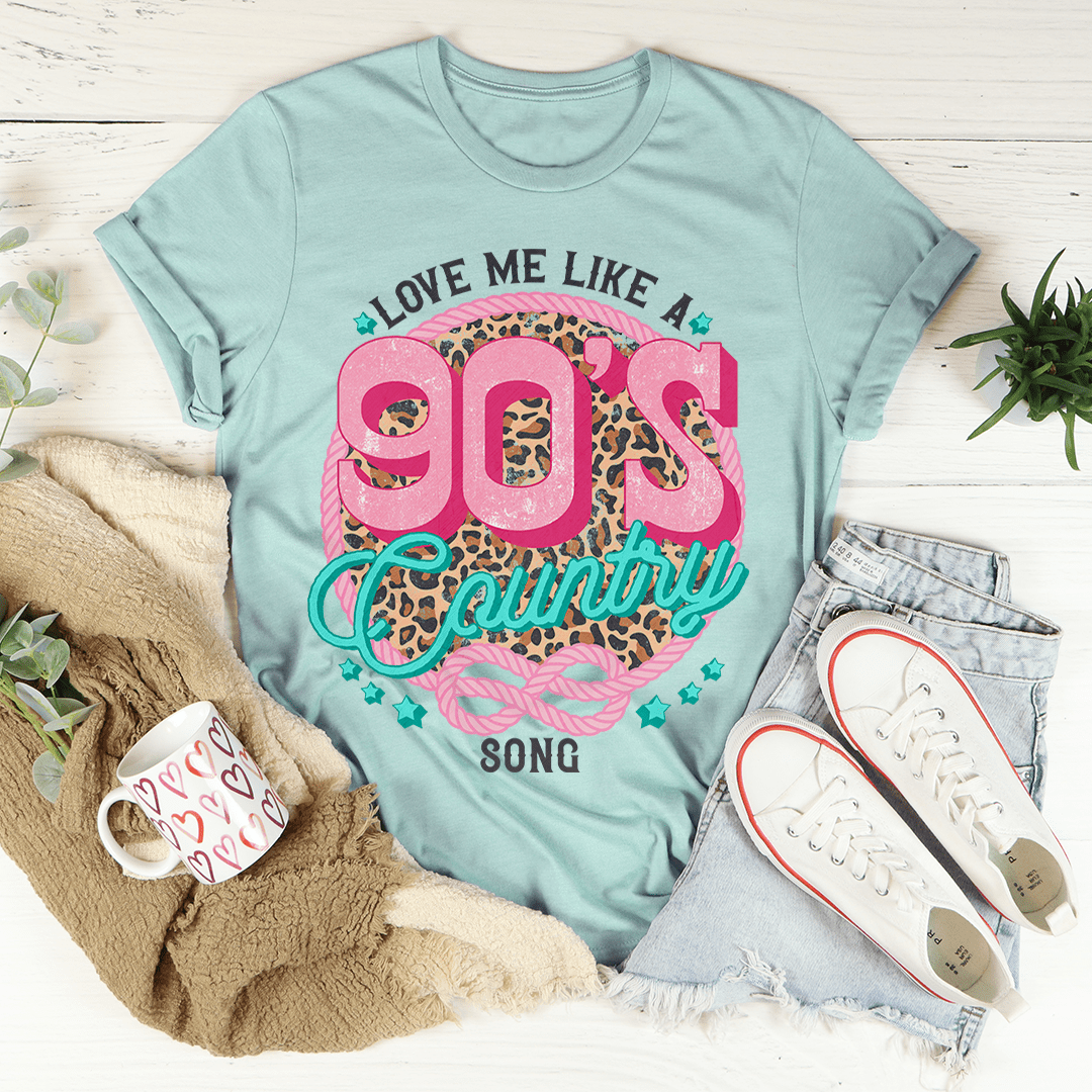 A stylish Love Me Like A 90's Country Song T-Shirt made of soft cotton, featuring a vibrant print that celebrates 90's country music.