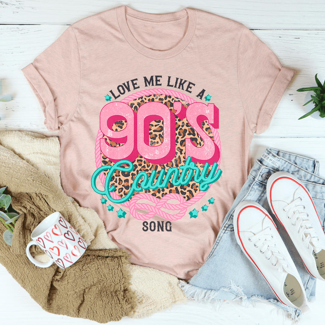 A stylish Love Me Like A 90's Country Song T-Shirt made of soft cotton, featuring a vibrant print that celebrates 90's country music.