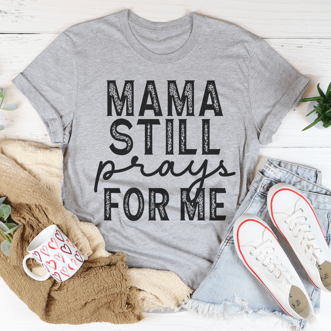 Mama Still Prays For Me T-Shirt in soft cotton, featuring a heartfelt design and durable stitching.