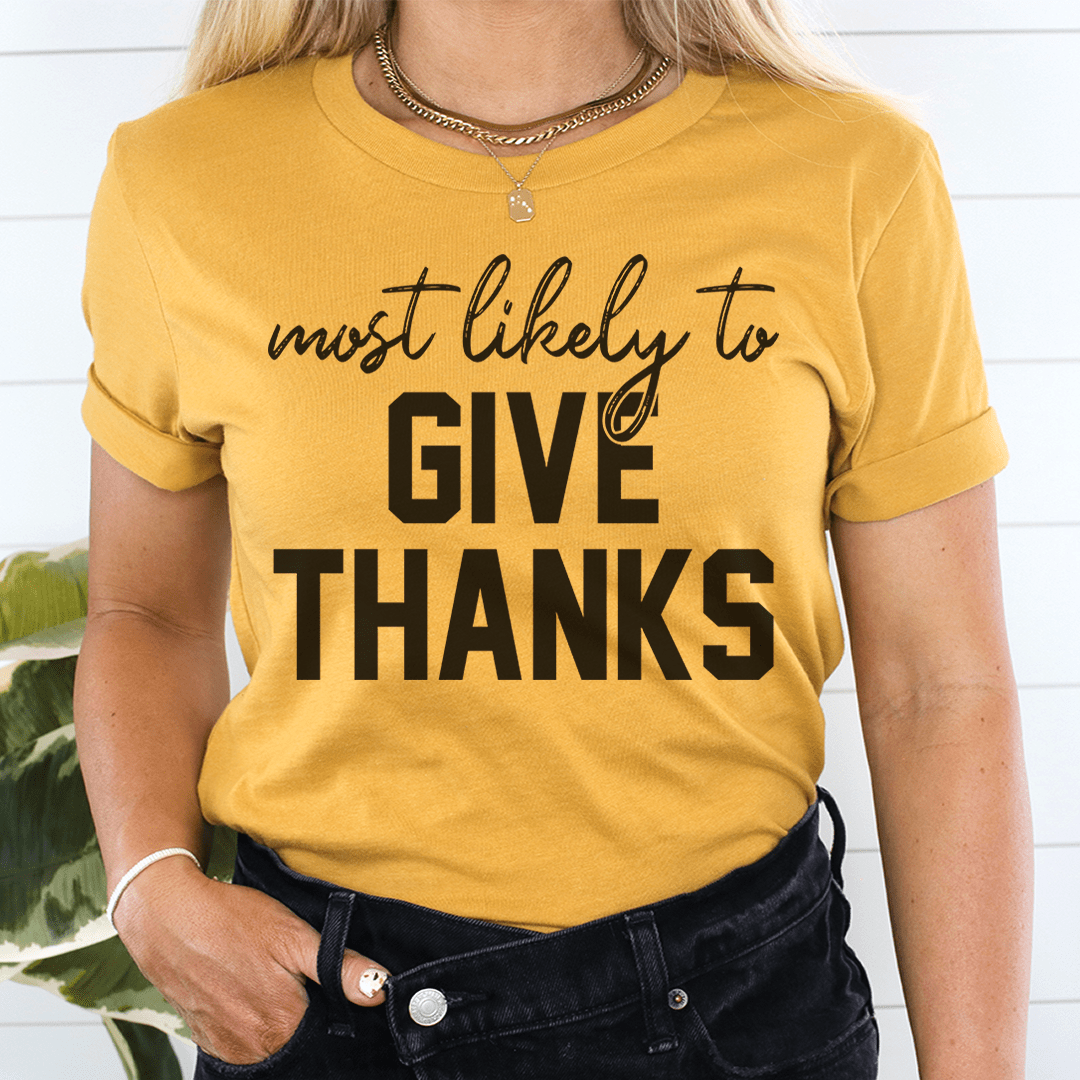 A soft, comfortable t-shirt with the phrase 'Most Likely To Give Thanks' printed on it, showcasing its durable double stitching.