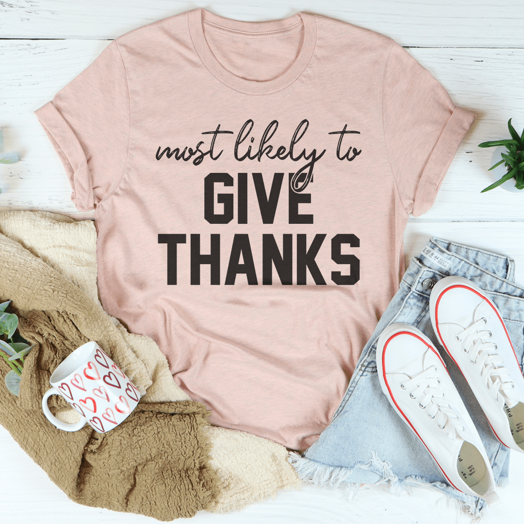 A soft, comfortable t-shirt with the phrase 'Most Likely To Give Thanks' printed on it, showcasing its durable double stitching.