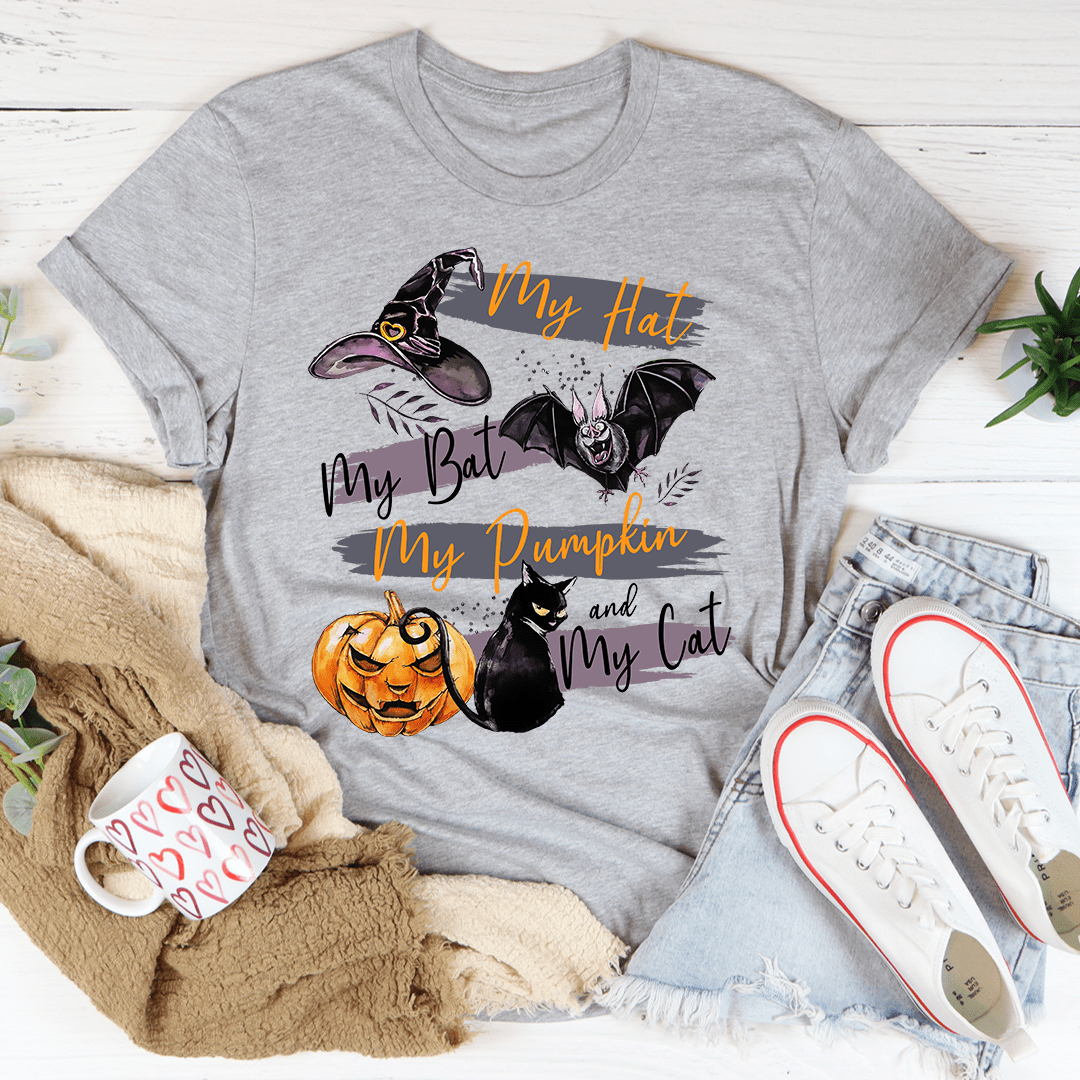 A comfortable and stylish t-shirt featuring a playful design with pumpkins and cats, made from soft ring-spun cotton.