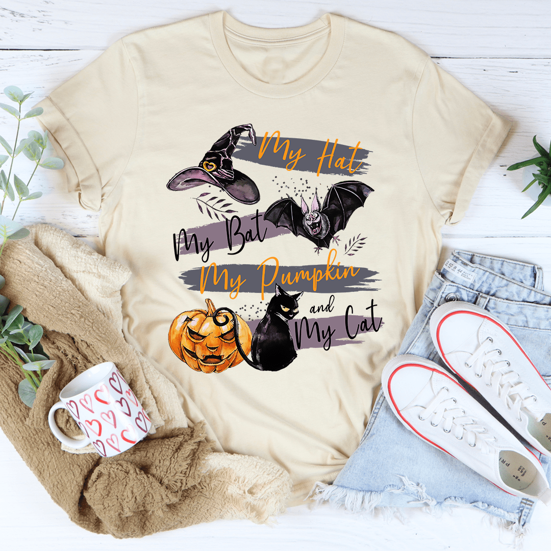 A comfortable and stylish t-shirt featuring a playful design with pumpkins and cats, made from soft ring-spun cotton.