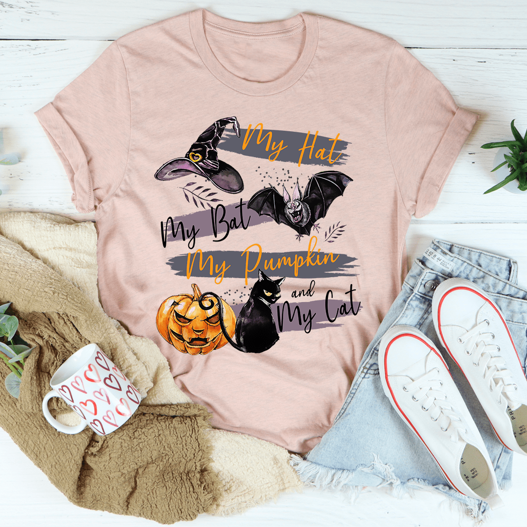 A comfortable and stylish t-shirt featuring a playful design with pumpkins and cats, made from soft ring-spun cotton.