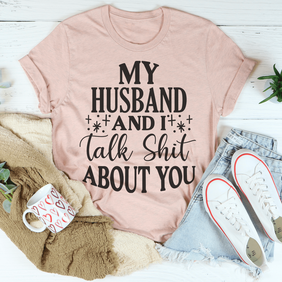 A humorous t-shirt featuring the phrase 'My Husband And I Talk Crap About You', made from soft cotton with double stitching.