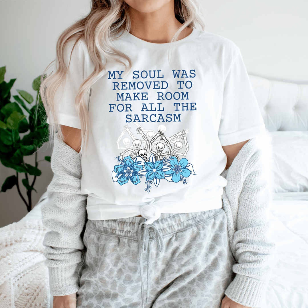 A stylish t-shirt featuring the phrase 'My Soul Was Removed To Make Room For All The Sarcasm' printed on soft ring-spun cotton fabric.