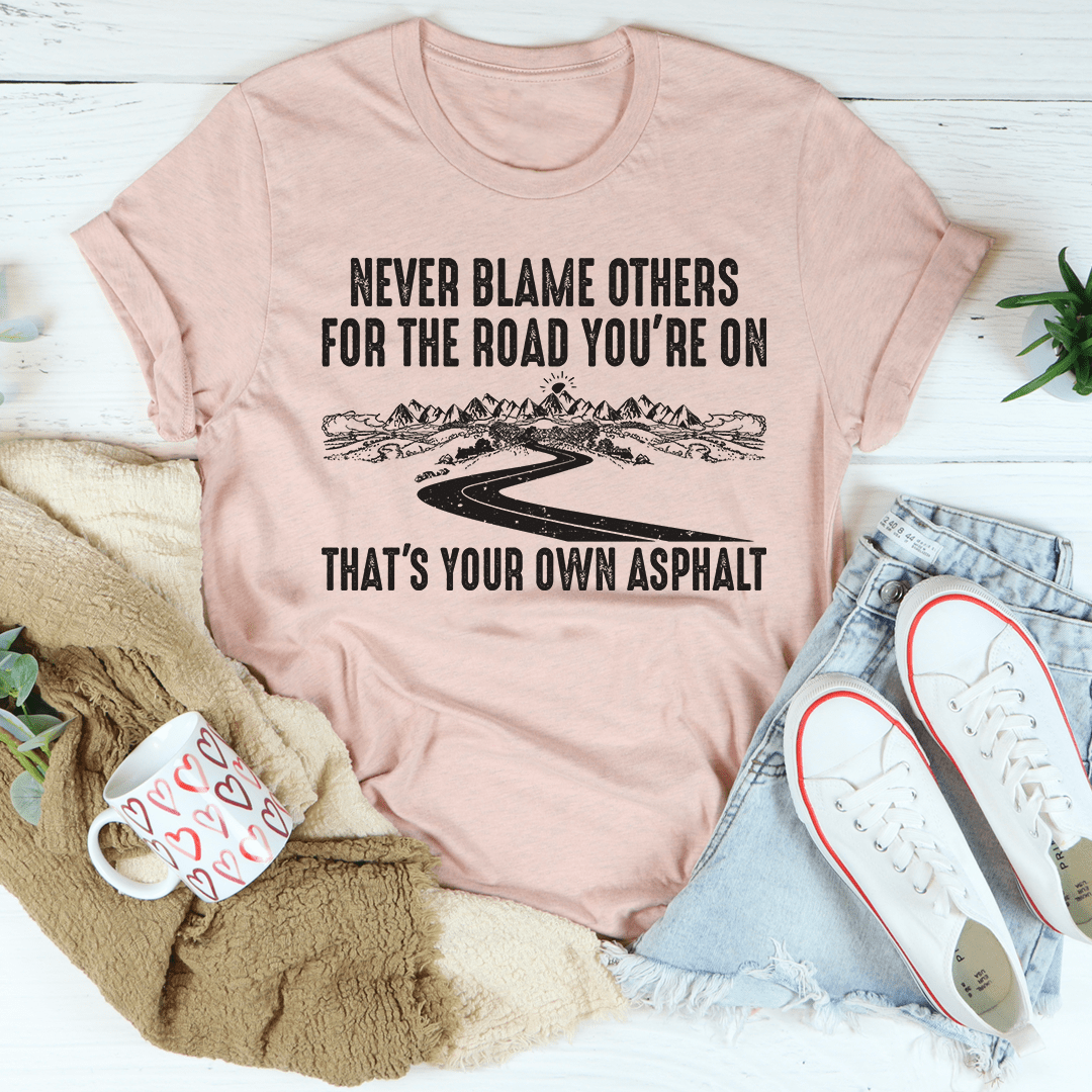 A stylish Never Blame Others Tee made from soft ring-spun cotton, featuring double stitching for durability and a comfortable fit.