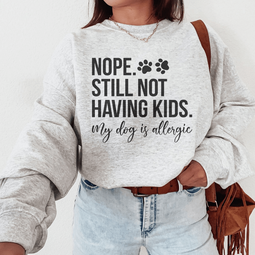 Cozy 'Nope Still Not Having Kids' sweats featuring unique designs by top artists, made from a soft cotton/poly fleece blend.