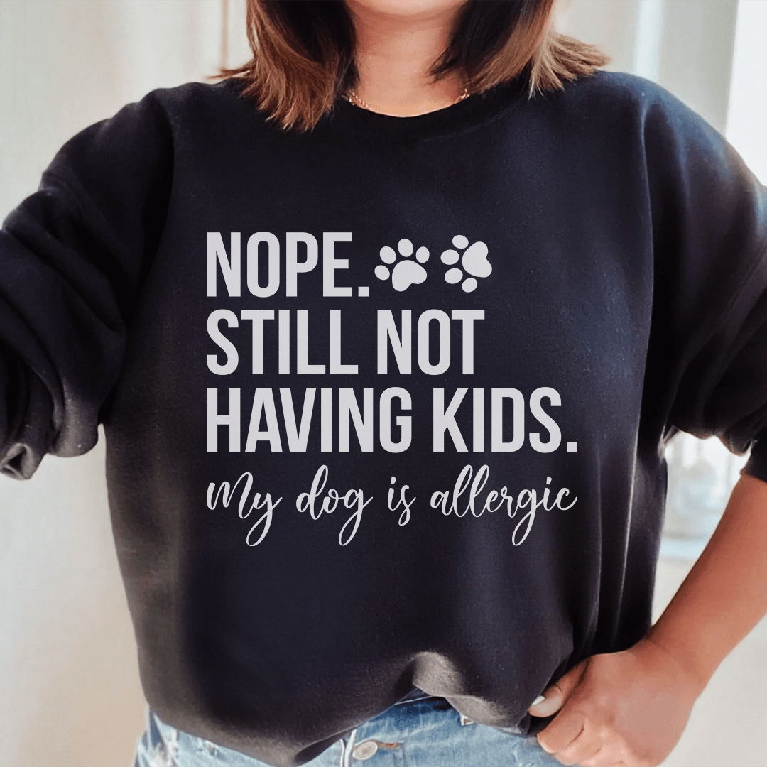 Cozy 'Nope Still Not Having Kids' sweats featuring unique designs by top artists, made from a soft cotton/poly fleece blend.