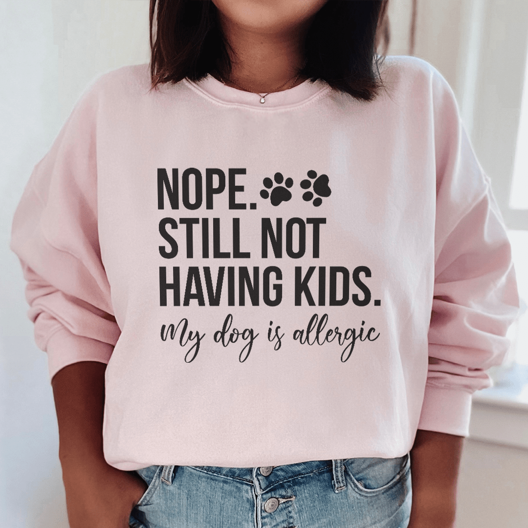 Cozy 'Nope Still Not Having Kids' sweats featuring unique designs by top artists, made from a soft cotton/poly fleece blend.