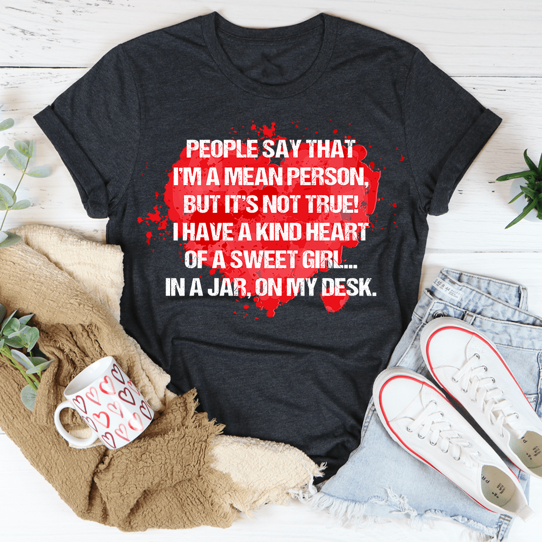 A stylish black t-shirt with the phrase 'People Say That I'm A Mean Person' printed in bold letters, showcasing its soft fabric and durable stitching.