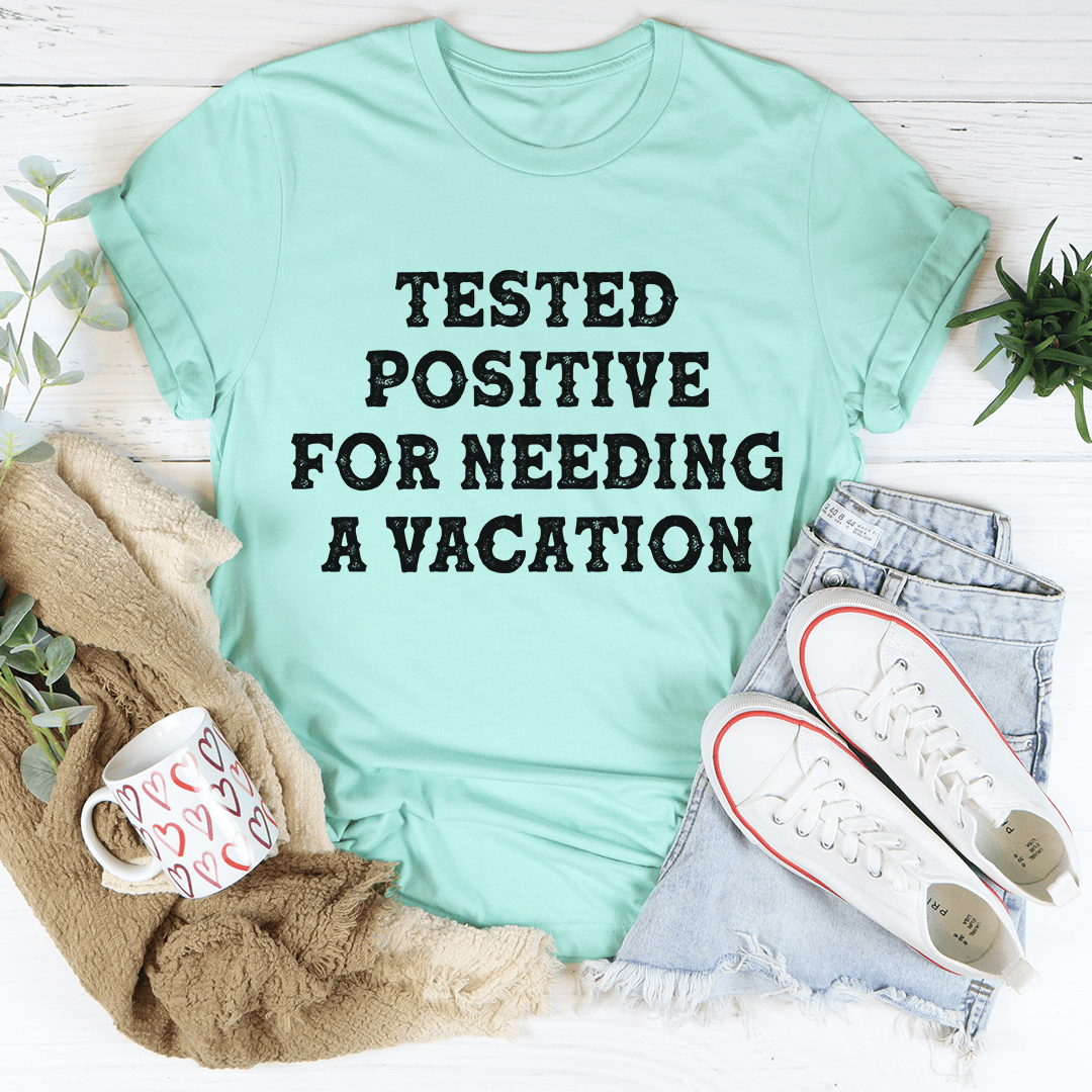 Positive I Need A Vacation T-Shirt in vibrant colors, showcasing its soft cotton fabric and durable stitching.