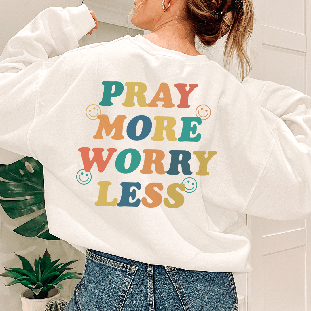 A cozy Pray More Worry Less hoodie featuring a cotton/poly fleece blend, designed for warmth and comfort with adjustable cuffs.