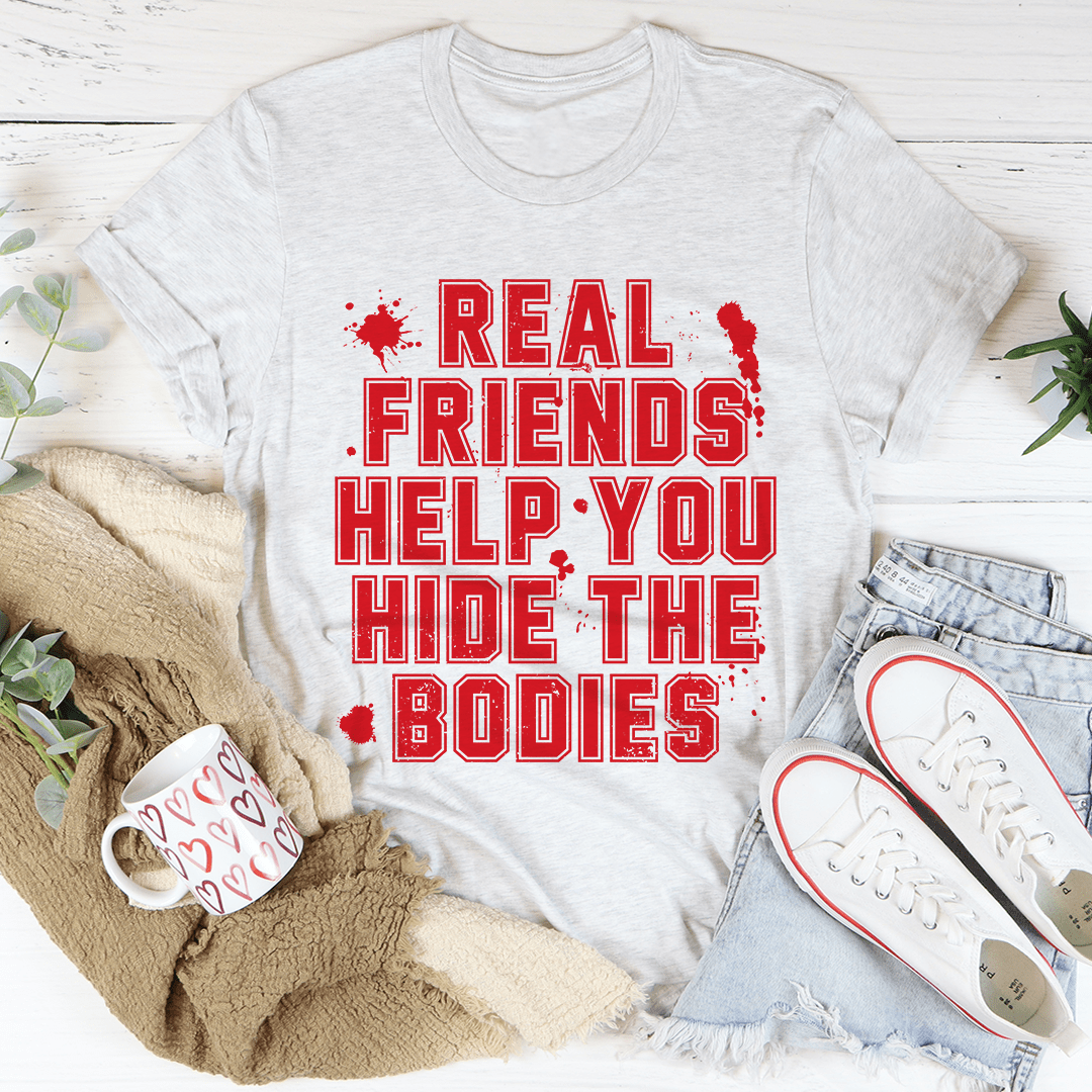 A stylish black t-shirt featuring the phrase 'Real Friends Help You Hide The Bodies' in bold white lettering, showcasing its comfortable fit and quality fabric.