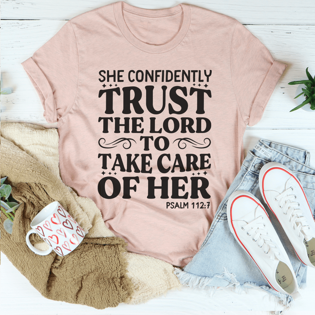 A stylish t-shirt featuring the phrase 'She Confidently Trust The Lord To Take Care Of Her', made from soft cotton with durable stitching.