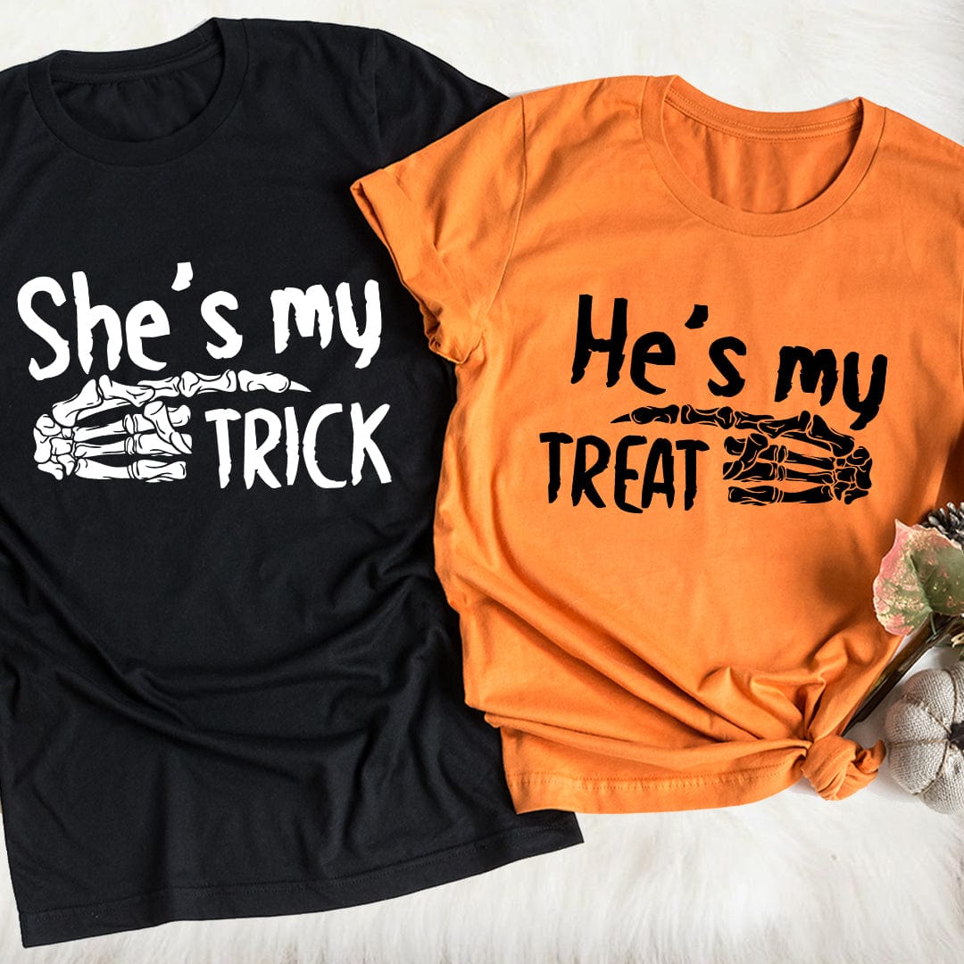 Couple wearing She's My Trick & He's My Treat T-Shirts, showcasing Halloween spirit with playful designs.