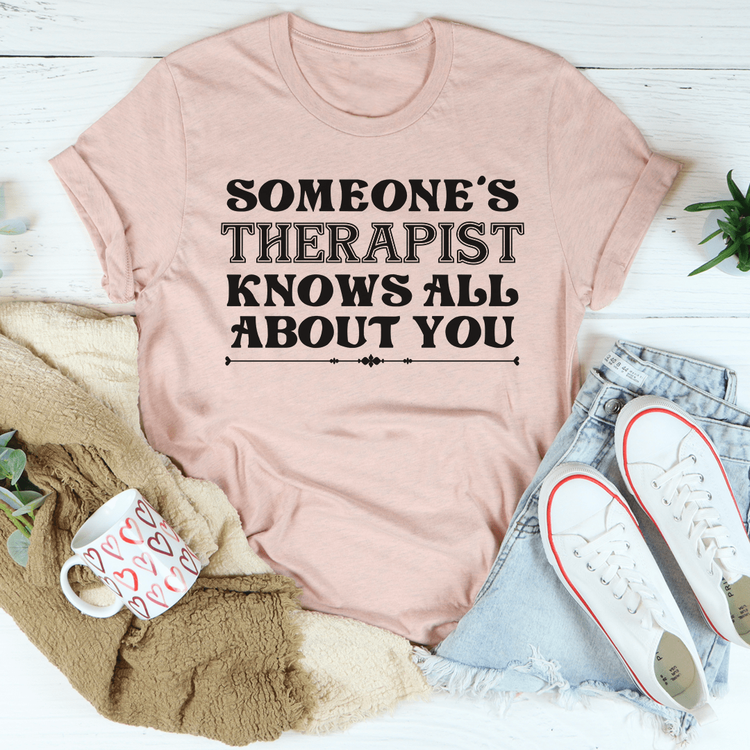 Someone's Therapist Knows All About You Tee, a soft cotton t-shirt with double stitching, available in various sizes.