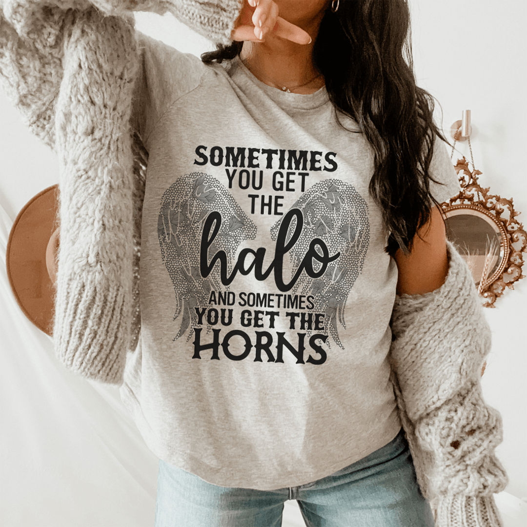 A stylish t-shirt featuring the phrase 'Sometimes You Get The Halo And Sometimes You Get The Horns', made from soft cotton with double stitching.