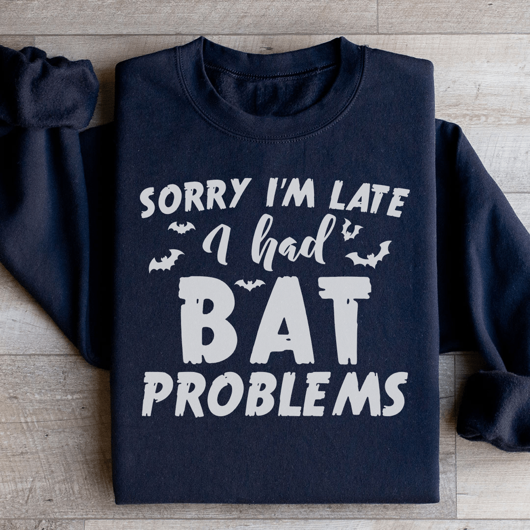 A cozy hoodie featuring the phrase 'Sorry I'm Late I Had Bat Problems' with a unique bat design, perfect for casual wear.