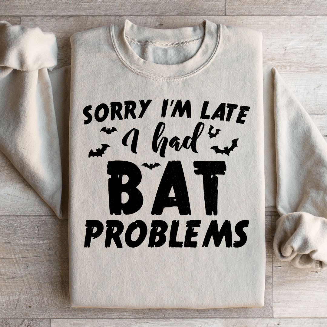 A cozy hoodie featuring the phrase 'Sorry I'm Late I Had Bat Problems' with a unique bat design, perfect for casual wear.