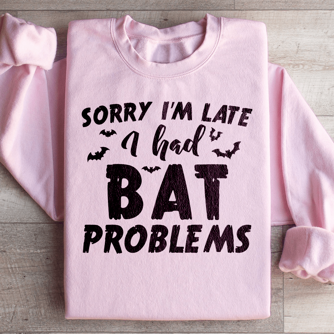 A cozy hoodie featuring the phrase 'Sorry I'm Late I Had Bat Problems' with a unique bat design, perfect for casual wear.