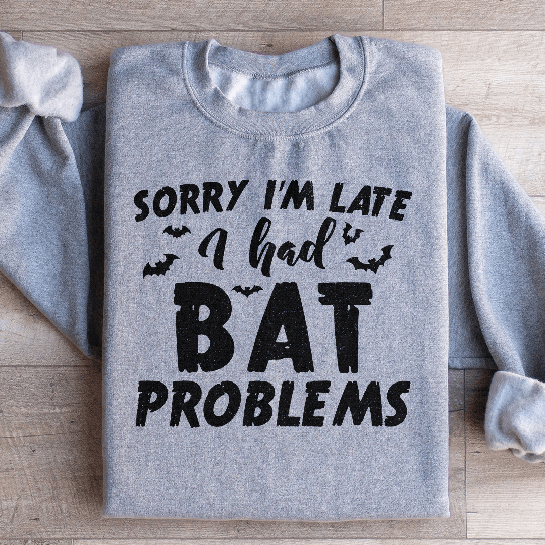 A cozy hoodie featuring the phrase 'Sorry I'm Late I Had Bat Problems' with a unique bat design, perfect for casual wear.