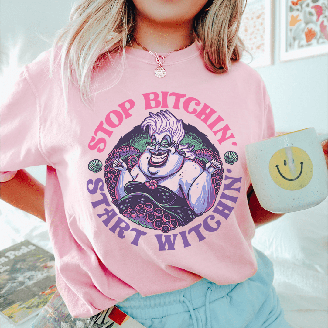 A stylish black t-shirt with the phrase 'Stop Bitchin' Start Witchin' printed in bold white letters.