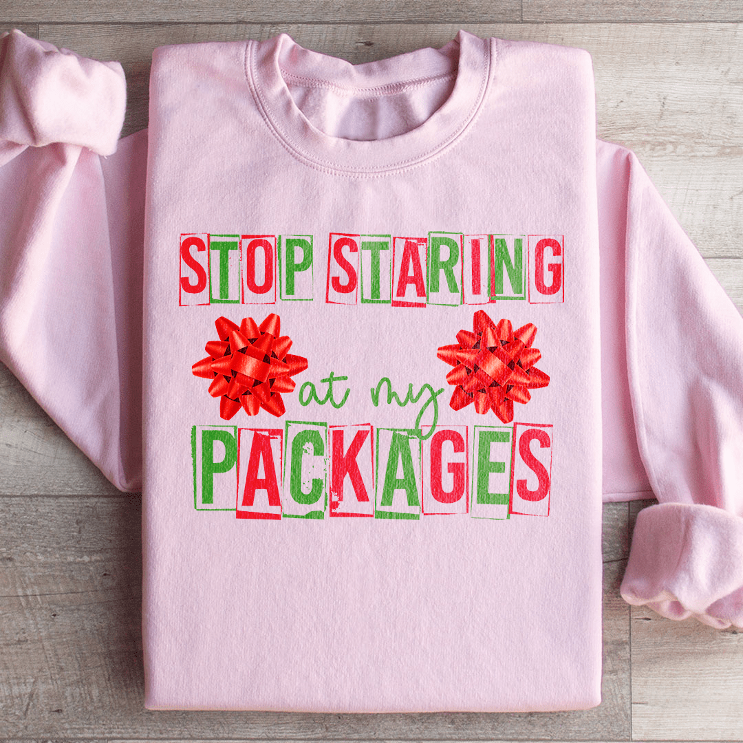 A cozy pair of 'Stop Staring At My Packages' sweats featuring unique artistic designs, made from a soft cotton/poly fleece blend.