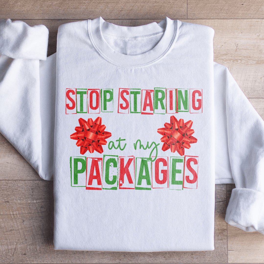 A cozy pair of 'Stop Staring At My Packages' sweats featuring unique artistic designs, made from a soft cotton/poly fleece blend.