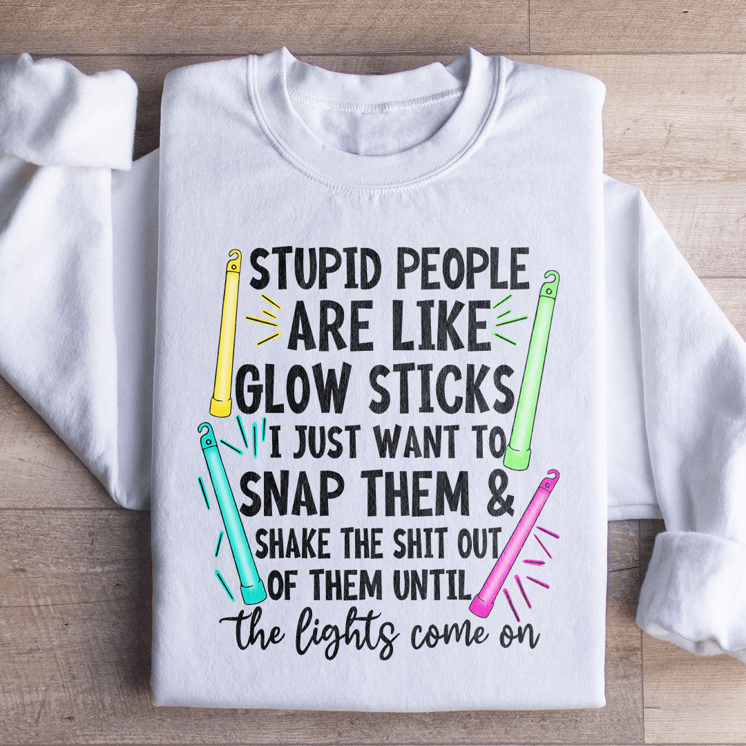 A cozy hoodie featuring the phrase 'Stupid People Are Like Glowsticks', made from a soft cotton/poly fleece blend.