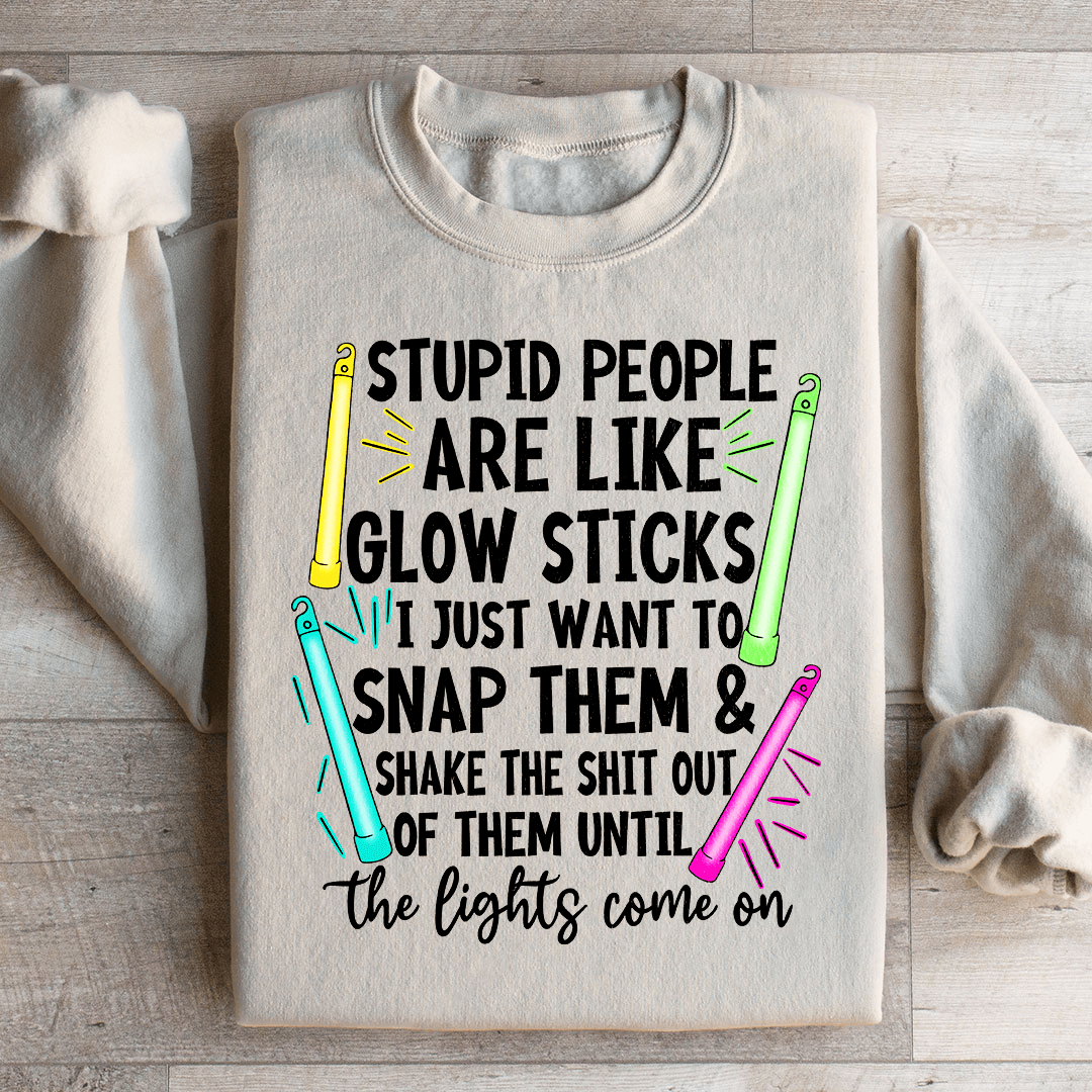 A cozy hoodie featuring the phrase 'Stupid People Are Like Glowsticks', made from a soft cotton/poly fleece blend.