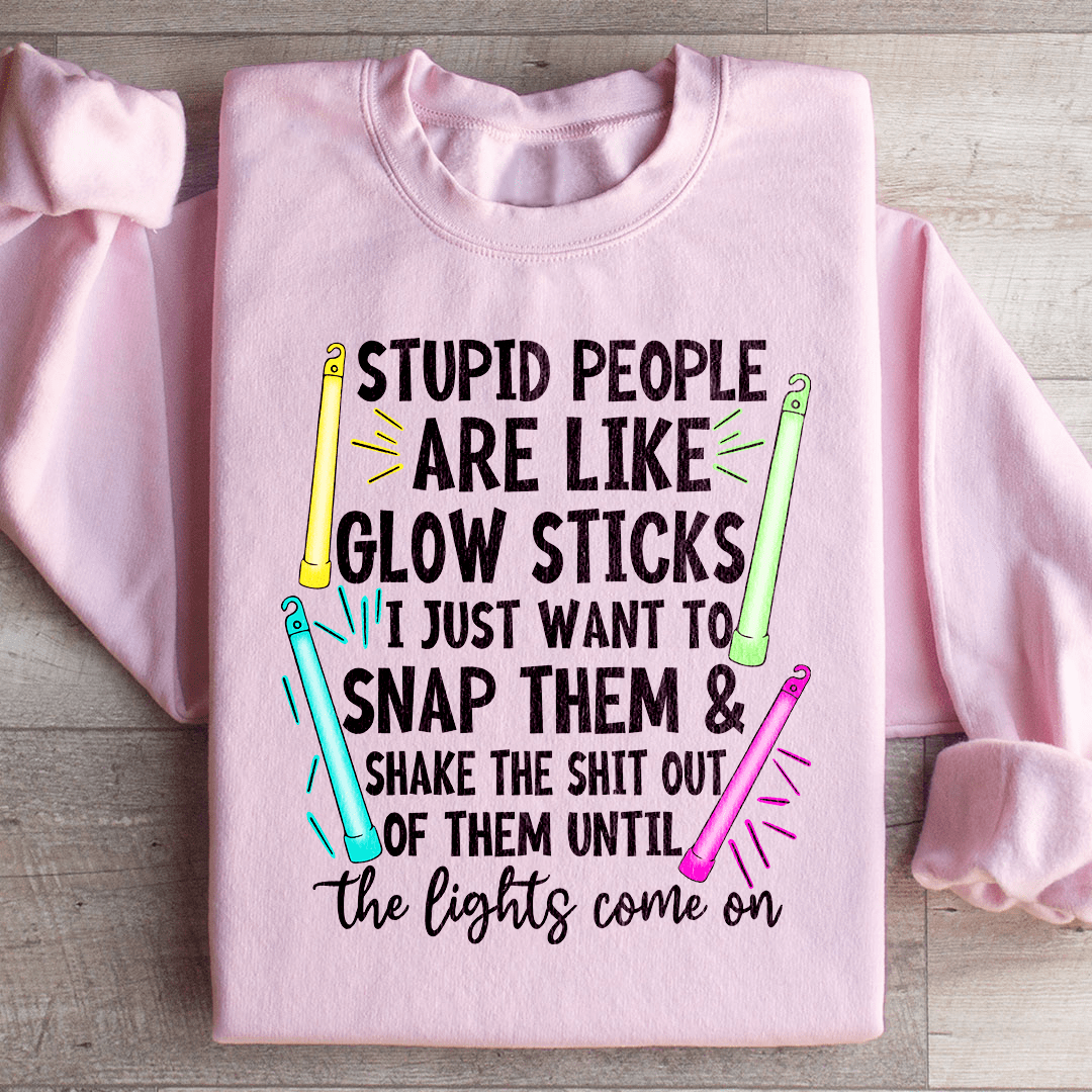 A cozy hoodie featuring the phrase 'Stupid People Are Like Glowsticks', made from a soft cotton/poly fleece blend.