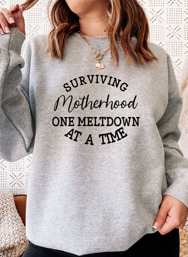 Cozy Surviving Motherhood Sweat Shirt featuring unique designs by top artists, made from soft cotton/poly fleece blend.