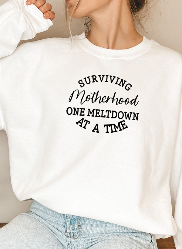 Cozy Surviving Motherhood Sweat Shirt featuring unique designs by top artists, made from soft cotton/poly fleece blend.