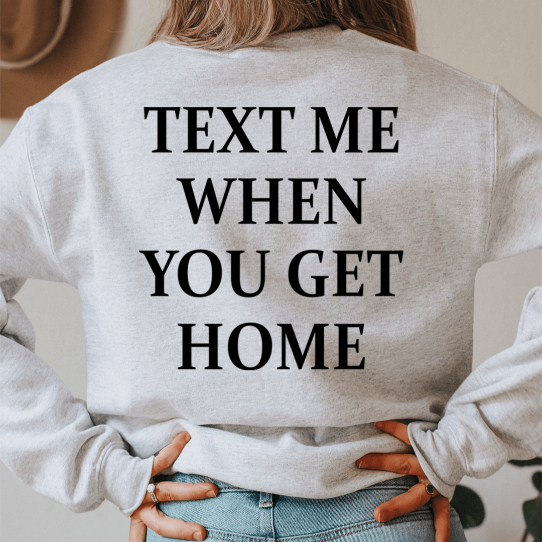 A cozy 'Text Me When You Get Home' hoodie featuring a unique design by top artists, made from a soft cotton/poly fleece blend.