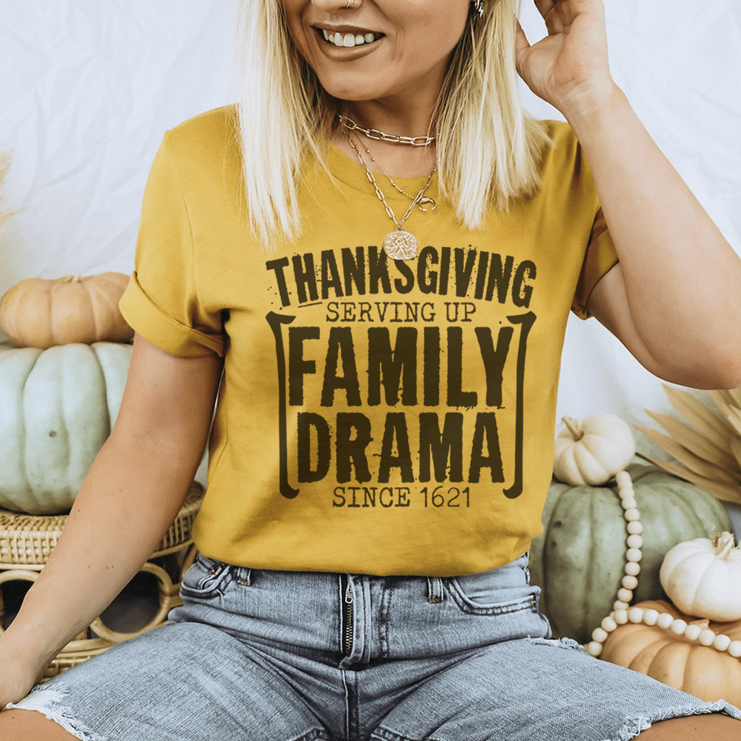 Thanksgiving Serving Up Drama Since 1621 T-Shirt featuring a playful design on soft cotton fabric, perfect for holiday celebrations.