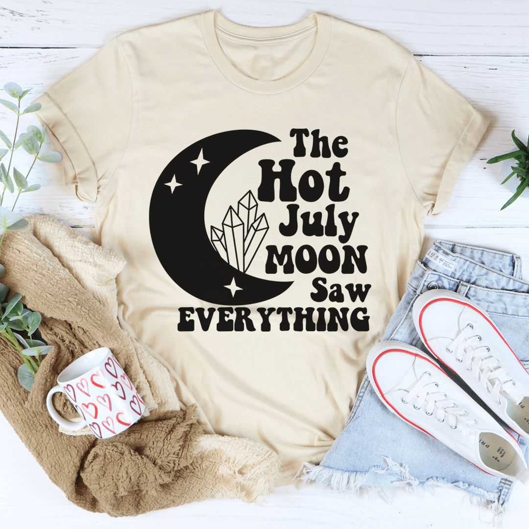 The Hot July Moon Saw Everything Tee, a soft and durable t-shirt made from ring-spun cotton, featuring double-stitched neckline and sleeves.