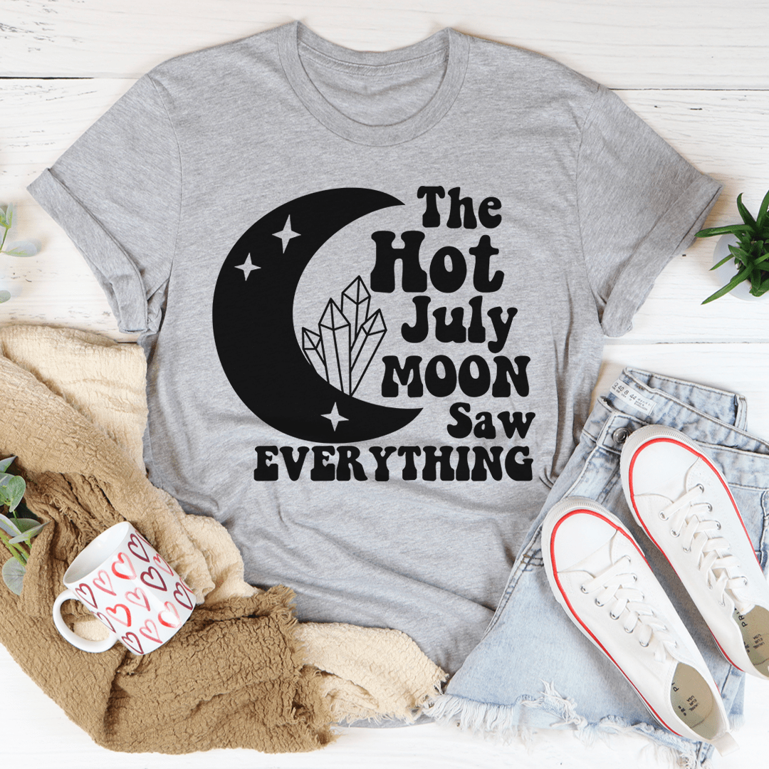 The Hot July Moon Saw Everything Tee, a soft and durable t-shirt made from ring-spun cotton, featuring double-stitched neckline and sleeves.