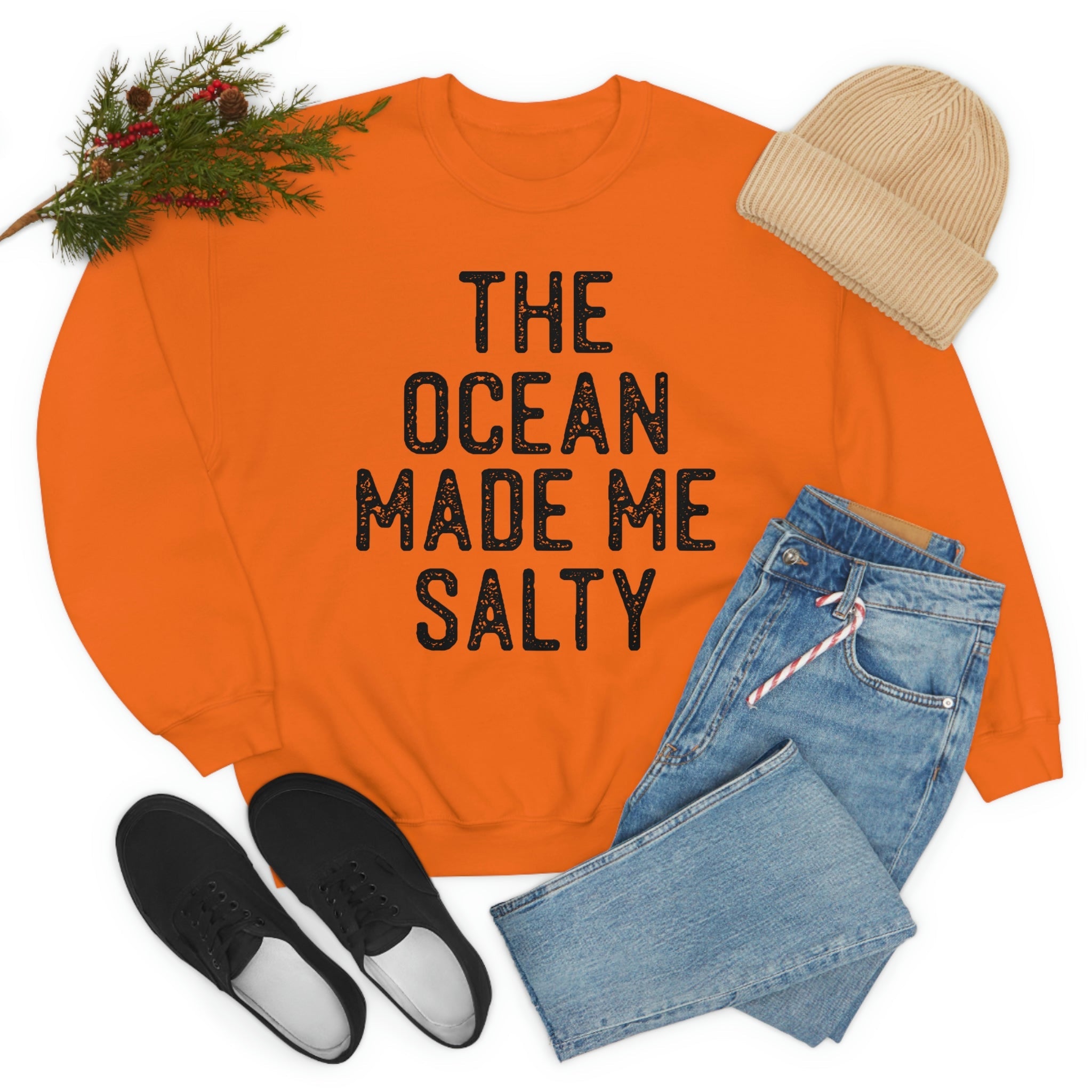 A stylish t-shirt with the phrase 'The Ocean Made Me Salty' printed on it, made from soft ring-spun cotton, showcasing its durability and comfort.