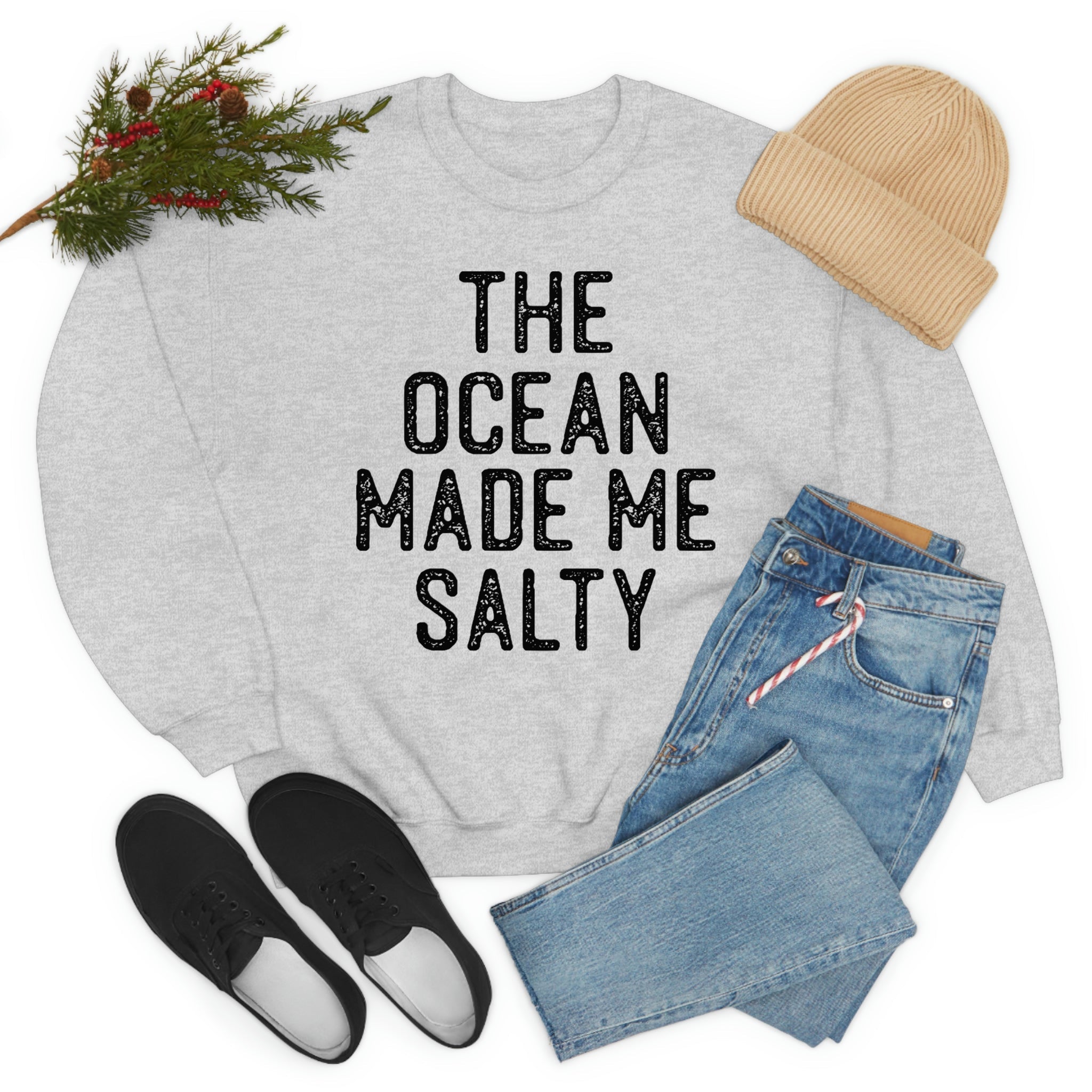 A stylish t-shirt with the phrase 'The Ocean Made Me Salty' printed on it, made from soft ring-spun cotton, showcasing its durability and comfort.