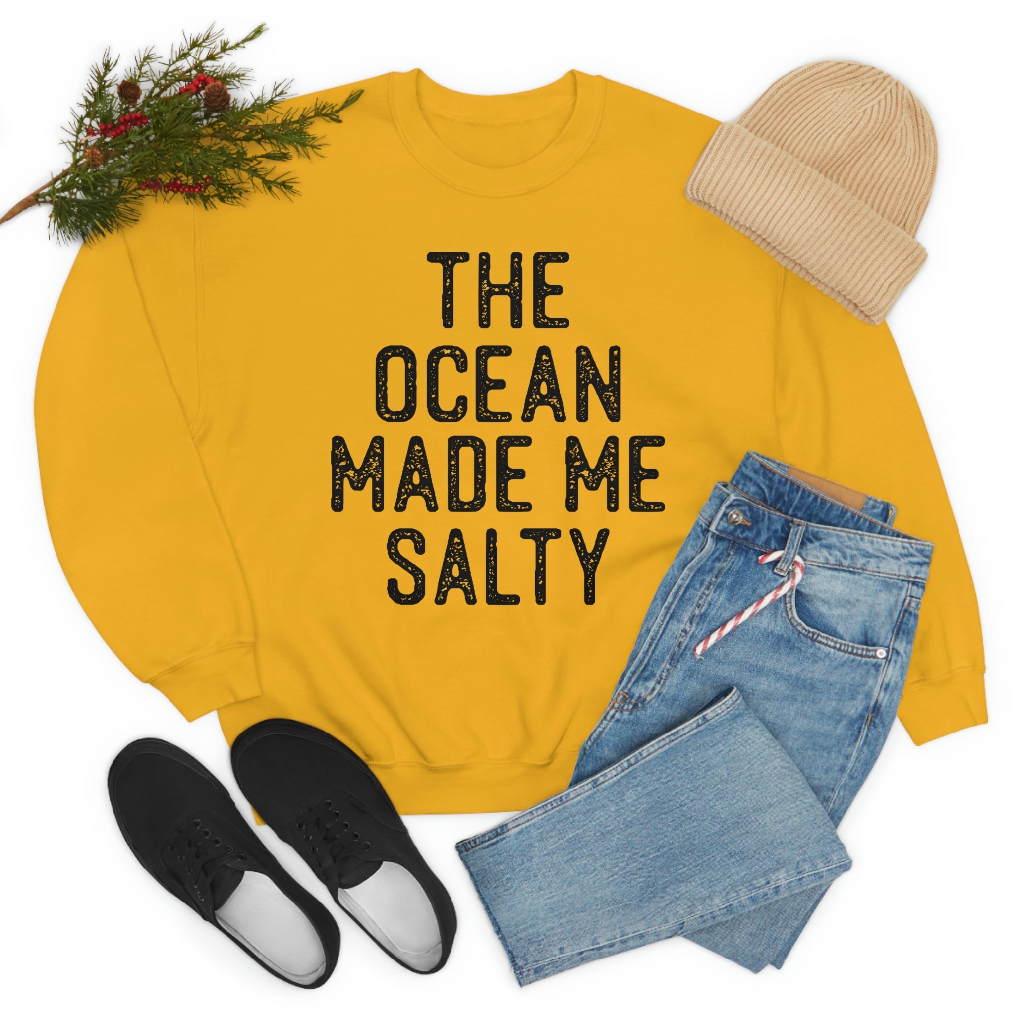 A stylish t-shirt with the phrase 'The Ocean Made Me Salty' printed on it, made from soft ring-spun cotton, showcasing its durability and comfort.