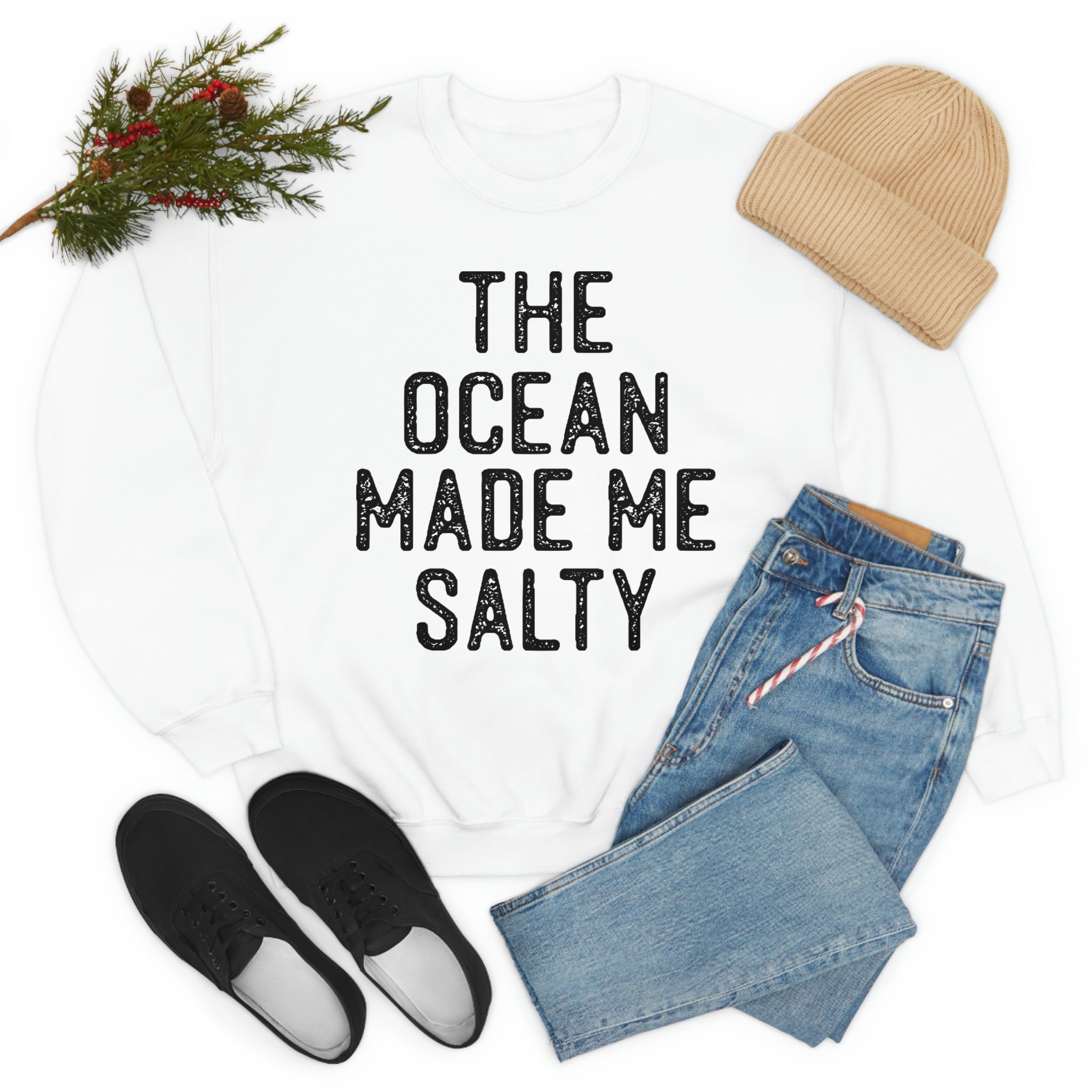 A stylish t-shirt with the phrase 'The Ocean Made Me Salty' printed on it, made from soft ring-spun cotton, showcasing its durability and comfort.