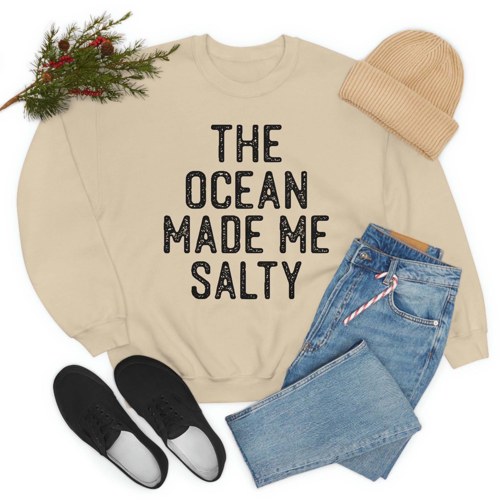 A stylish t-shirt with the phrase 'The Ocean Made Me Salty' printed on it, made from soft ring-spun cotton, showcasing its durability and comfort.