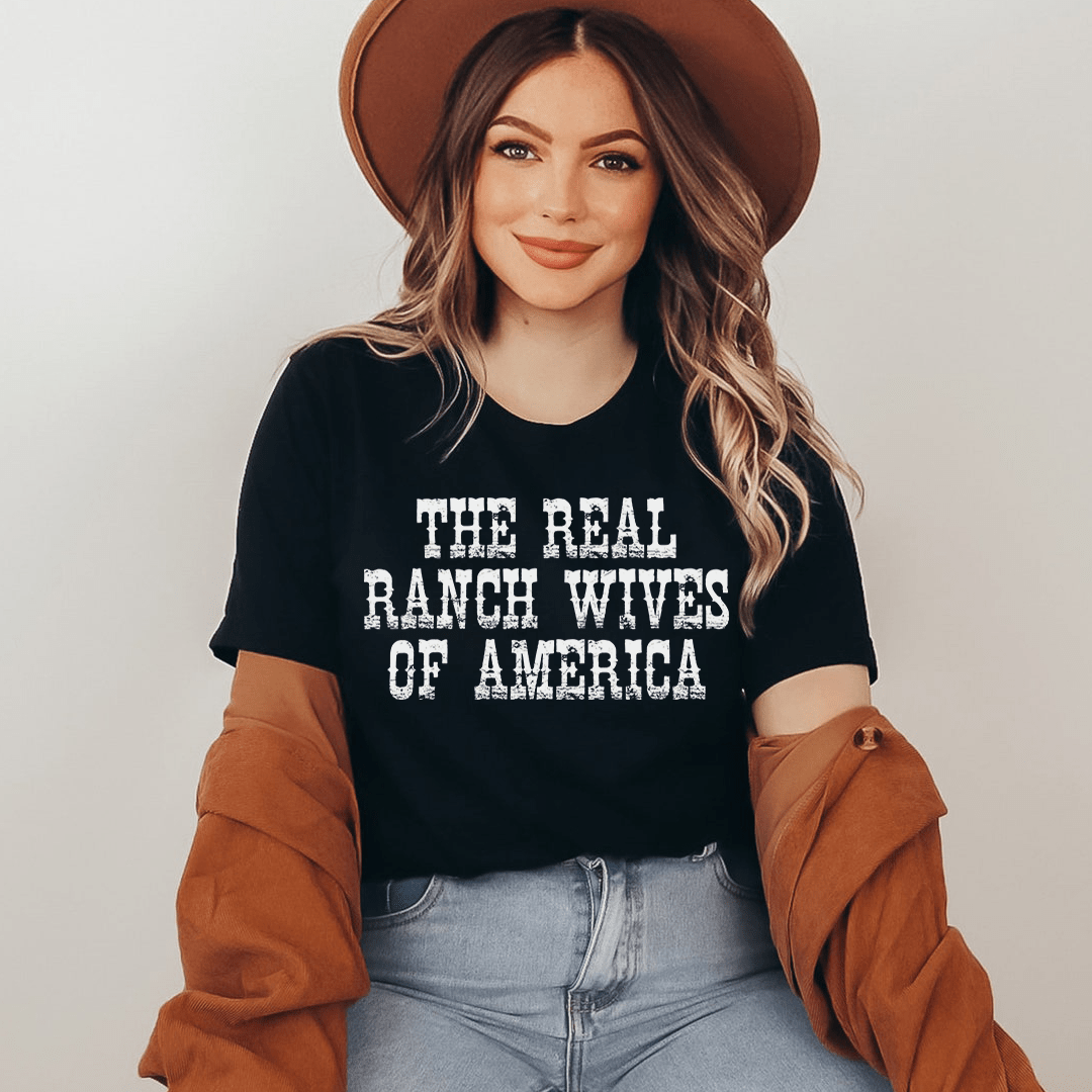 The Real Ranch Wives Of America T-Shirt displayed on a mannequin, showcasing its soft cotton fabric and durable stitching.