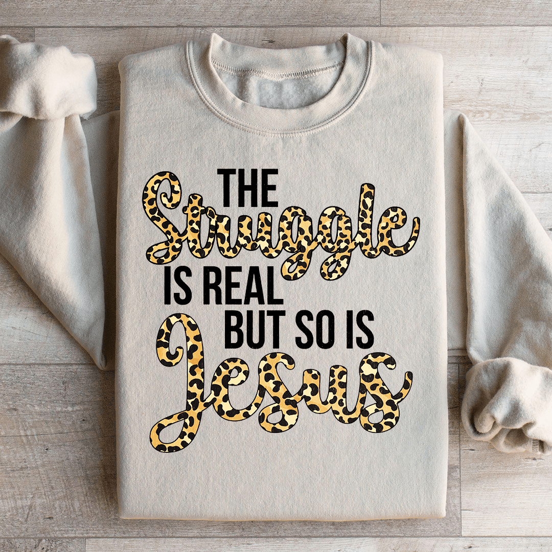 Cozy hoodie featuring the phrase 'The Struggle Is Real But So Is Jesus', designed by top artists, showcasing a unique artistic design.