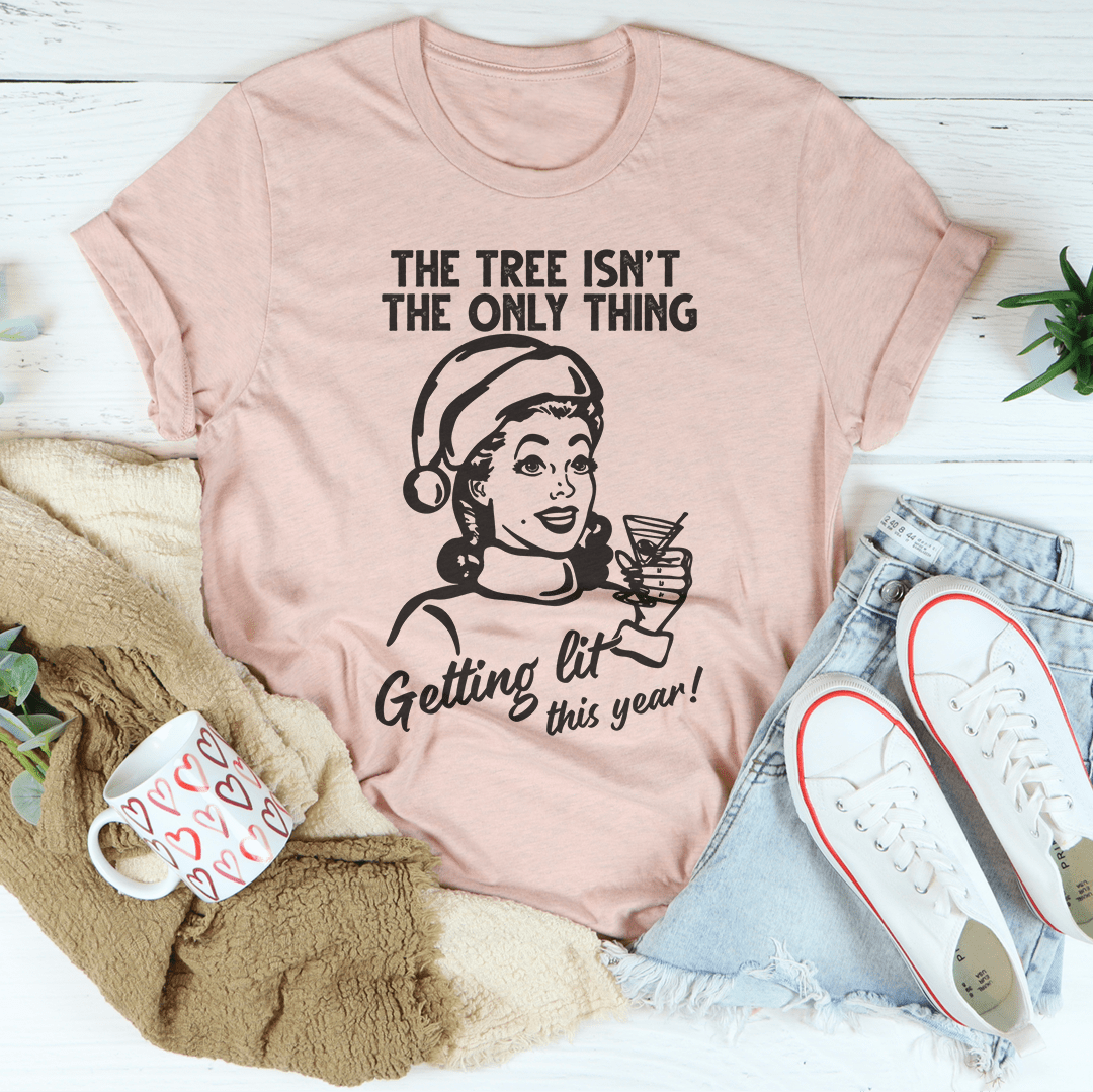 A festive t-shirt featuring the phrase 'The Tree Isn't The Only One Getting Lit This Year', made from soft cotton with double stitching.