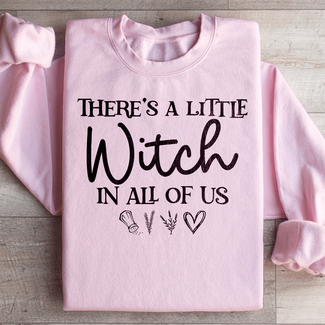 A stylish black t-shirt featuring the phrase 'There's A Little Witch In All Of Us' in a whimsical font, showcasing its soft fabric and durable stitching.