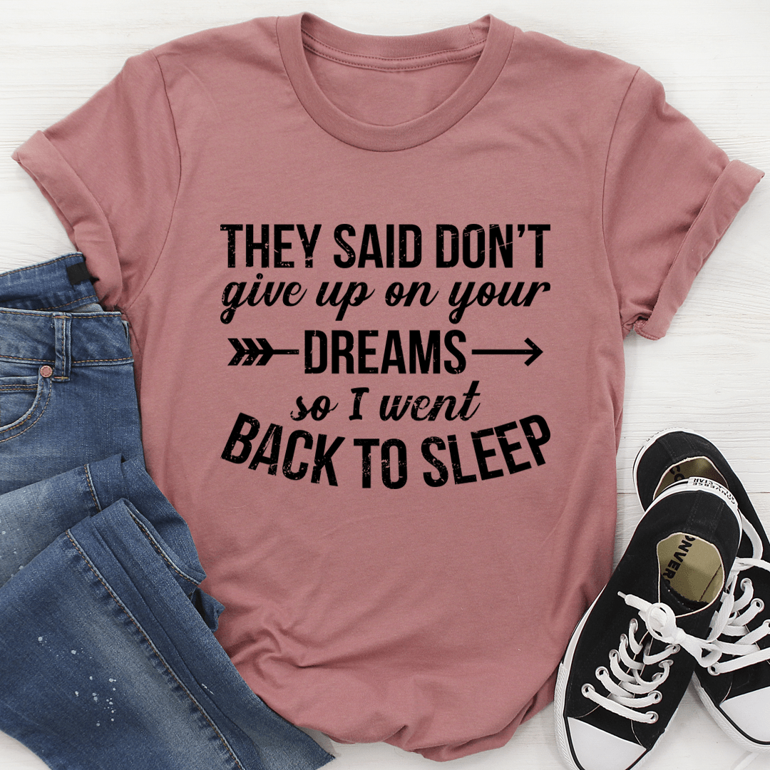 A stylish t-shirt featuring the motivational phrase 'They Said Don't Give Up On Your Dreams' printed on soft ring-spun cotton fabric.