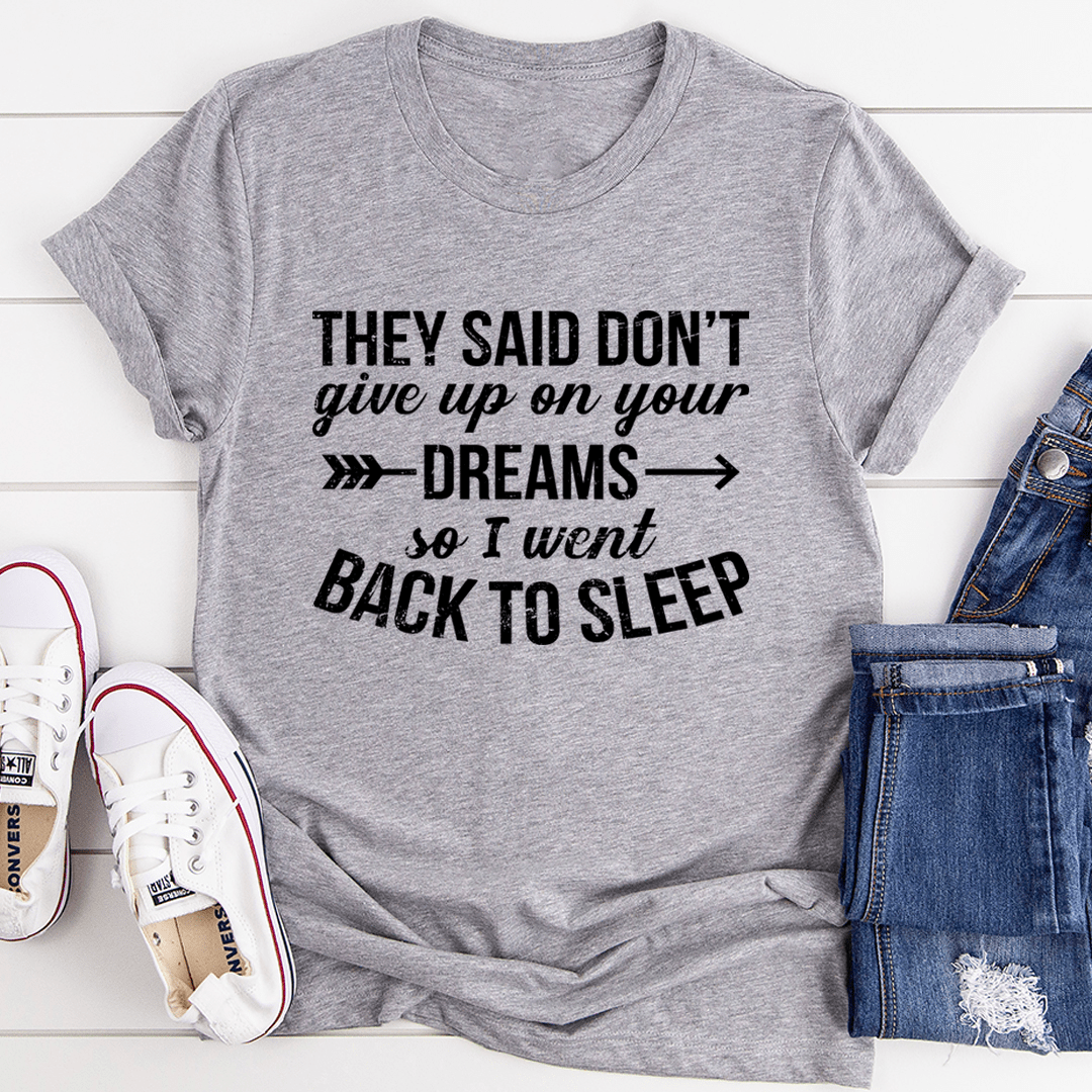 A stylish t-shirt featuring the motivational phrase 'They Said Don't Give Up On Your Dreams' printed on soft ring-spun cotton fabric.